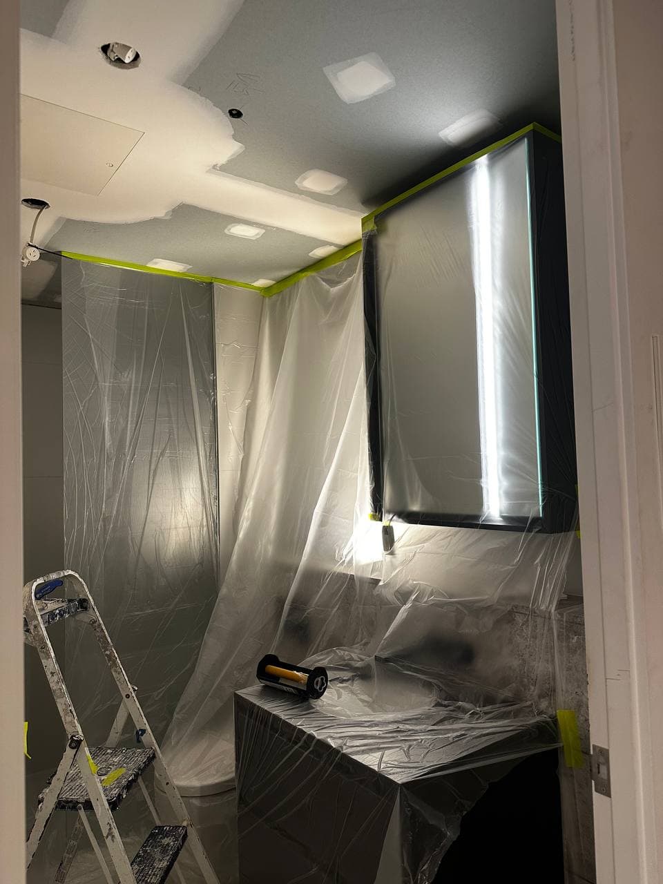 MAK Painting team protecting bathroom fixtures before painting